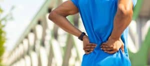 A man holds his back due to chronic pain before ablation for nerve pain