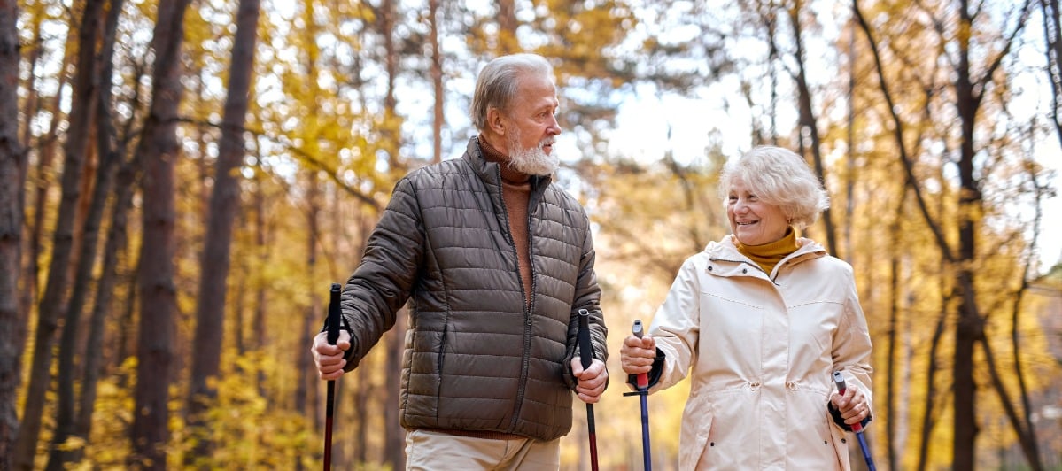 How Nerve Ablation Works for Lower Back Pain-5-Hikers Two hikers in winter coats smile as they walk through a forest