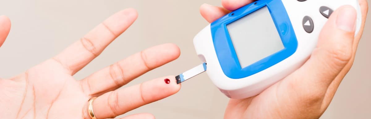 Making Sense of Glucose Management Indicators-2 A person with diabetes pricks their finger to check glucose managment indicators