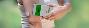 A runner checks her glucose management indicators on the go with her phone