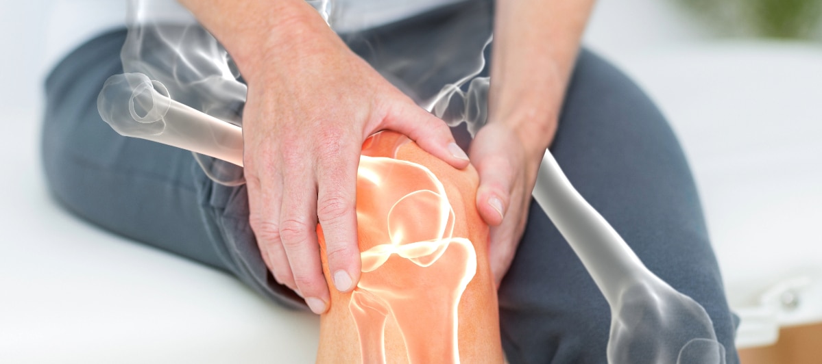 Pain Management Maryland-1 (1) A woman experience knee pain holding her knee.