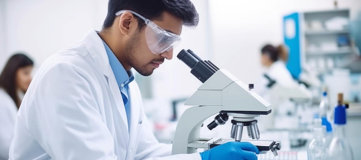 Peripheral Nerve Stimulators for Pain An Overview-4-Microscope A scientist looks through a microscope to examine test results