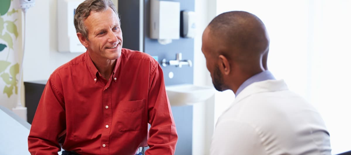 Peripheral Nerve Stimulators for Pain An Overview-5-Patient A patient smiles as he talks to his doctor about peripheral nerve stimulator treatment