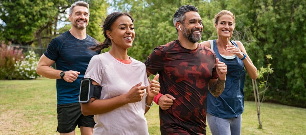 Peripheral Nerve Stimulators for Pain An Overview-6-Runners A group of runners smiles as they jog through a park after peripheral nerve stimulator treatment
