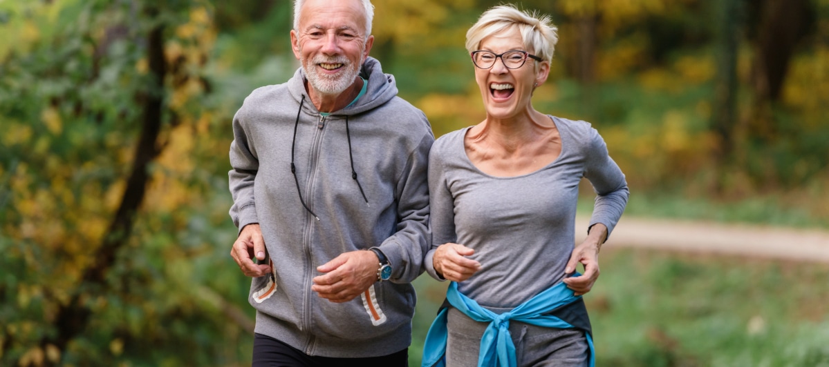 Relieve Your Back Pain with Sacroiliac Joint Injections-6-Exercise Two older people laugh as they take a jog through a park