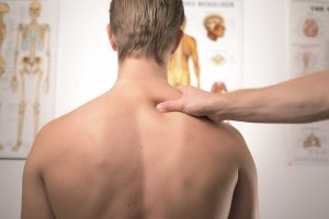 A man with long covid getting a neck examination