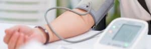 A patient uses a digital blood pressure monitor to look for hypertension