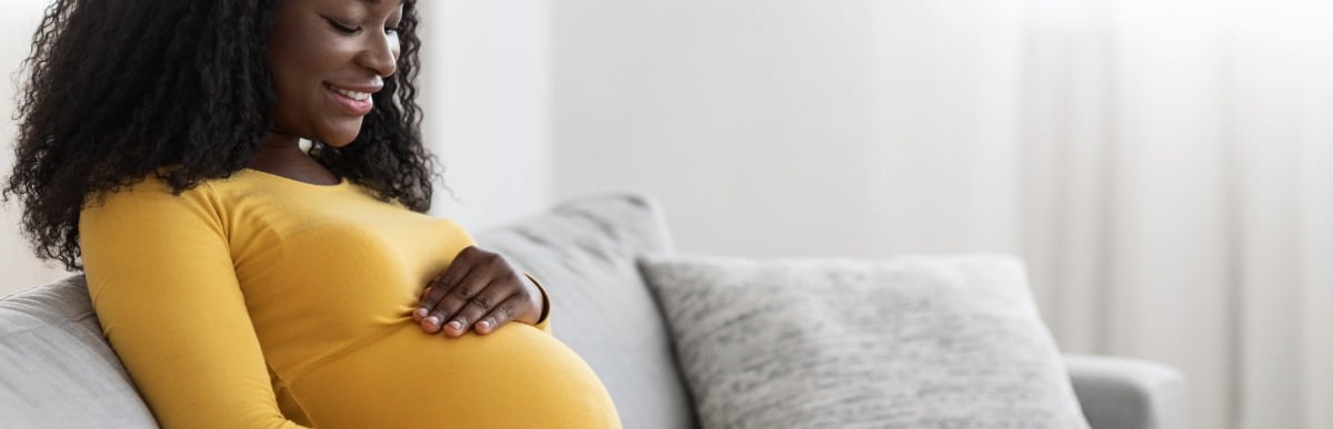 Stage 2 Hypertension When Blood Pressure Gets Serious-4 A pregnant woman smiles as she holds her stomach
