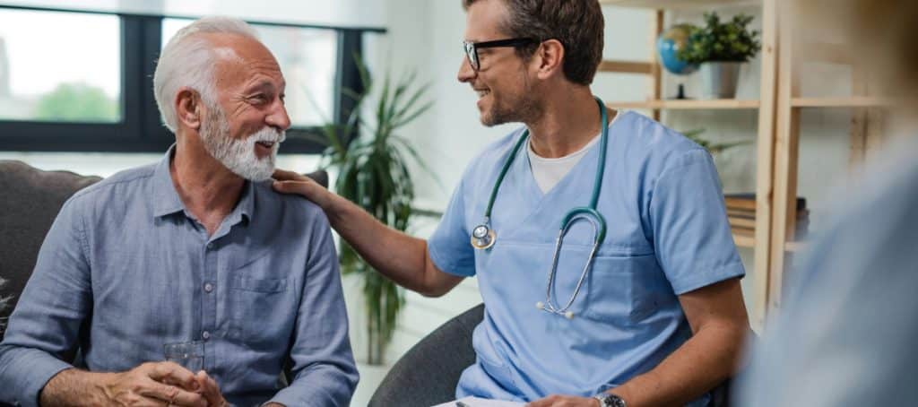 An elderly man meeting with his pain management doctor