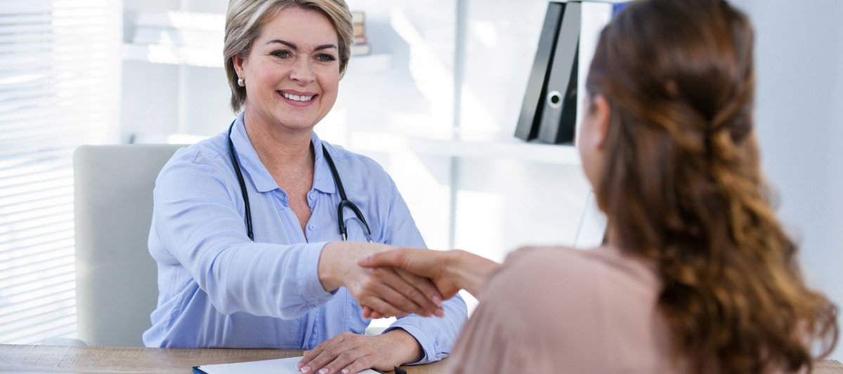 The Best Injections for Neck Pain-7-Shake A doctor smiles and shakes her patient's hand