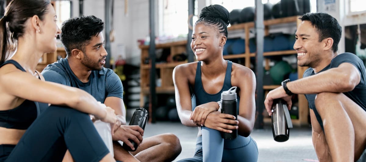 The Relationship Between Inflammation and Weight Gain-5-Gym A group of friends smile as they take a break after a workout at the gym to reduce inflammation and weight gain
