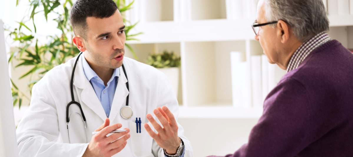 The Role of Steroid Injections in Arthritis Treatment-4-Doctor A doctor in a lab coat reviews an arthritis diagnosis with a patient