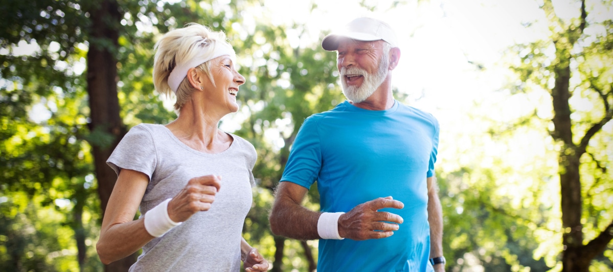 The Role of Steroid Injections in Arthritis Treatment-7-Exercise An older couple smiles as they walk briskly through the park after steroid injections for arthritis