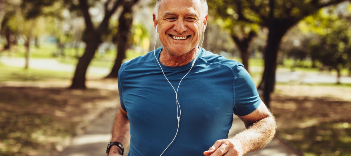 The Top 5 Benefits of Neural Therapy-3-Runner A man smiles as he jogs while wearing headphones due to neural therapy