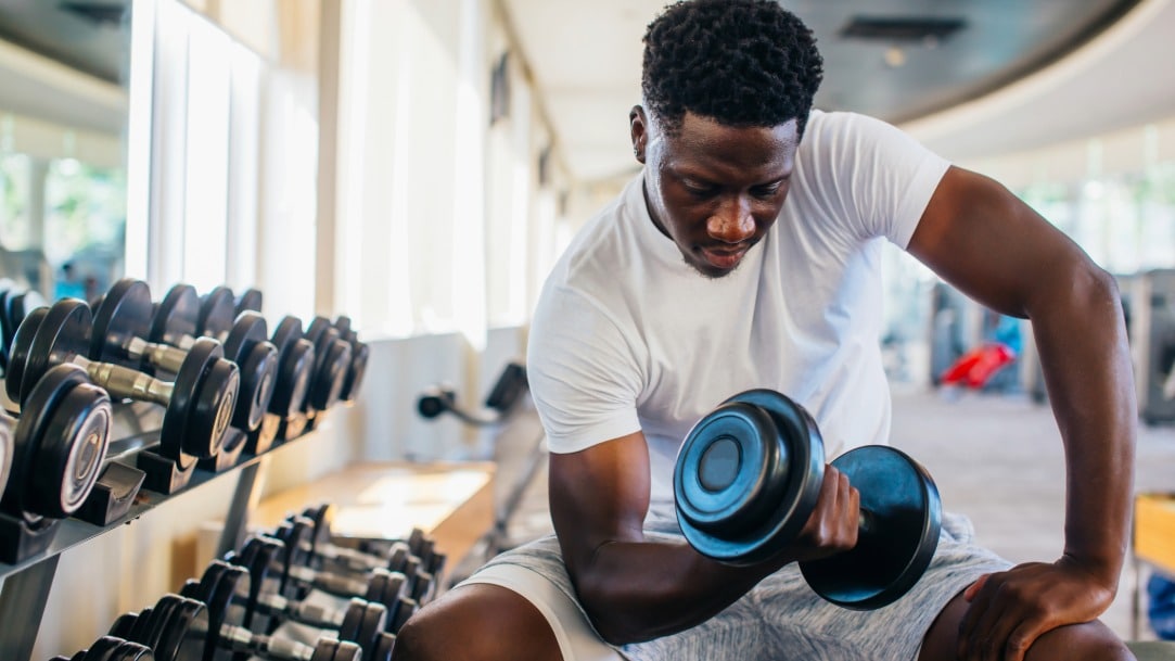 The Ultimate Guide to Vitamins for Gut Health - 2026-09-17T111509.503 A man curls a dumbbell weight at a gym after Emsculpt Neo treatment
