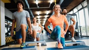 A woman smiles as she participates in an exercise class as part of her injury recovery