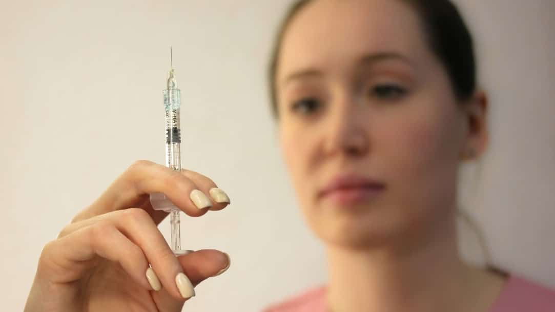 The Ultimate Guide to Vitamins for Gut Health - 2026-10-01T114911.276 A doctor prepares an injection needle before an injection as part of injury recovery