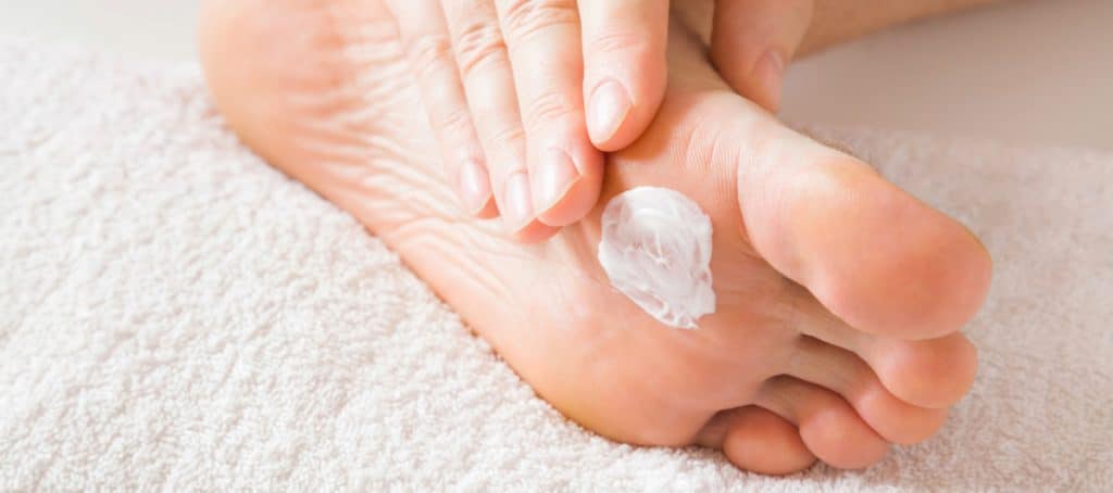 A person moisturizes their foot as part of proper diabetic foot care