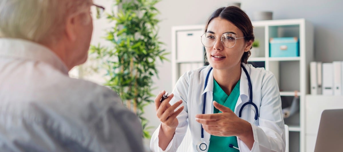 Understanding Spinal Decompression What You Need to Know-4-Doc A doctor in a lab coat speaks with her patient about spinal decompression