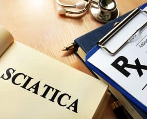 Sciatica word written on a page with a RX page next to it.