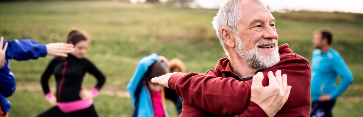 What Is Injection Therapy-3 A man smiles as he stretches his arm before a jog after injection therapy
