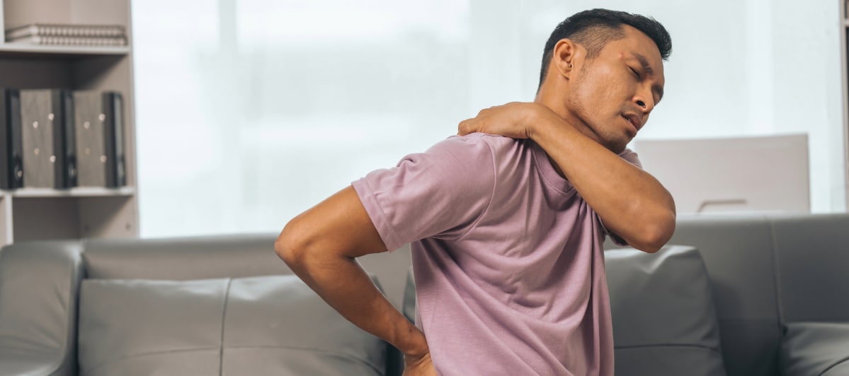 What Is the Best Treatment for Spinal Stenosis-3-Back Pain A man grabs his back in pain from spinal stenosis