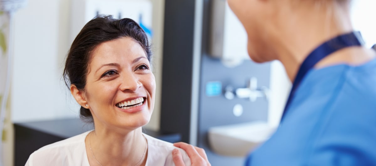 What Alternative Medicine Can Do For You-5-Patient A patient smiles as her doctor puts a hand on her shoulder and discusses regenerative medicine treatment