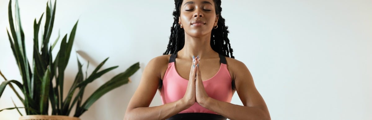 What to Expect When Getting a Glucose Monitoring Implant (17) A woman sits on the floor and meditates to ease lower back pain after surgery