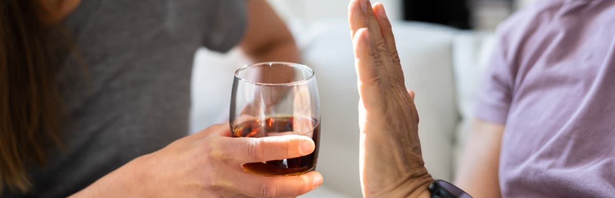 What to Expect When Getting a Glucose Monitoring Implant (18) A person denies a glass of wine to help reduce lower back pain after surgery