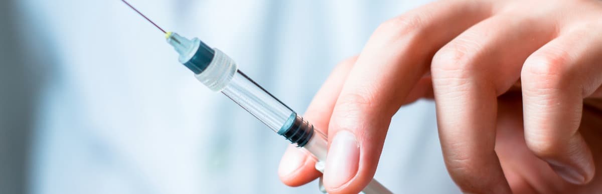 What to Expect When Getting a Glucose Monitoring Implant (20) A doctor holds an injection needle that treats lower back pain after surgery
