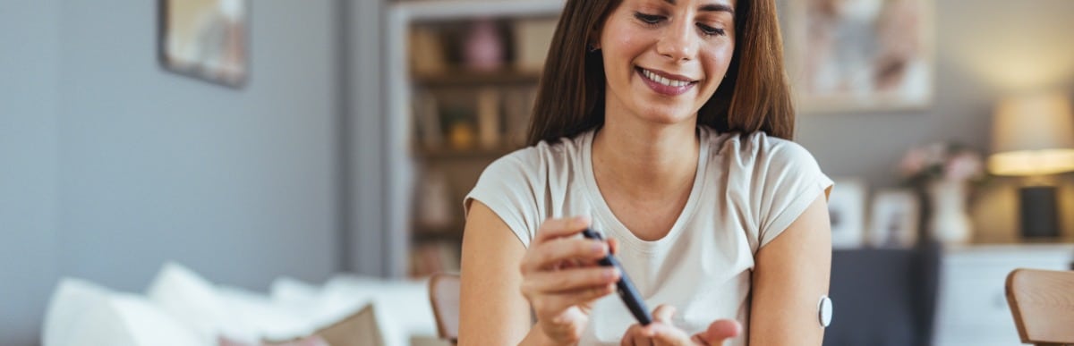 Why Sugar Balance Matters for Your Health-3 A woman pricks her finger to check her sugar balance