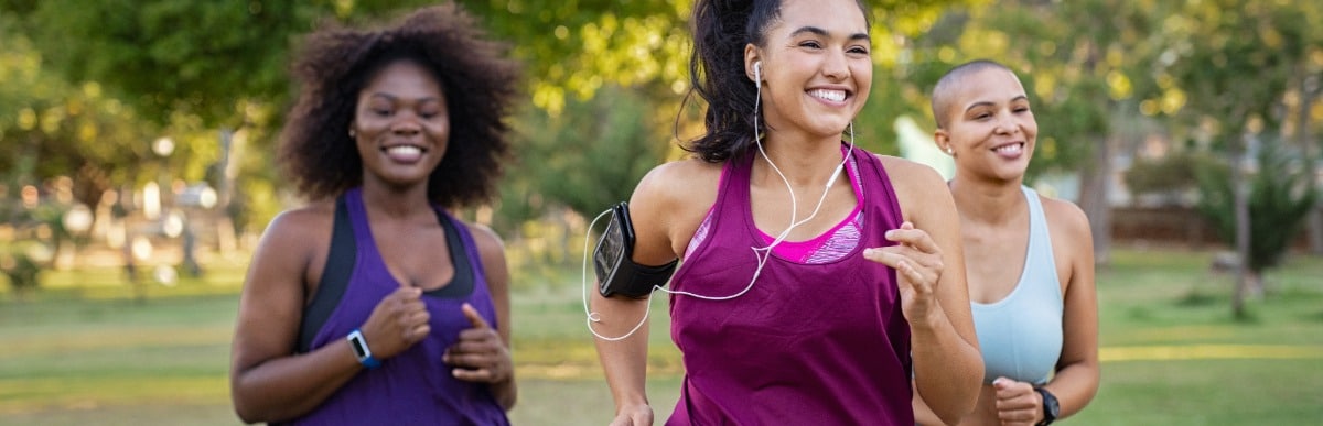 Why Sugar Balance Matters for Your Health-4 Three friends smile as they jog through a park