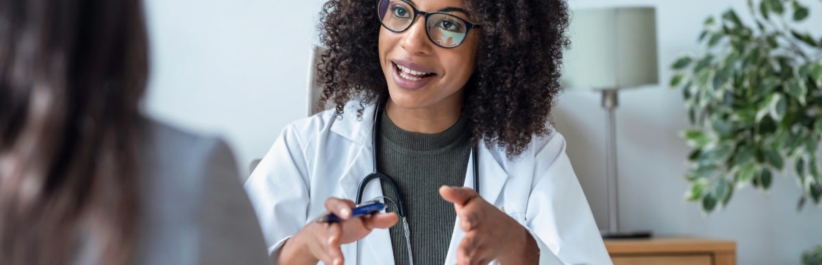 Why Sugar Balance Matters for Your Health-5 A doctor in a lab coat discusses sugar balance with her patient