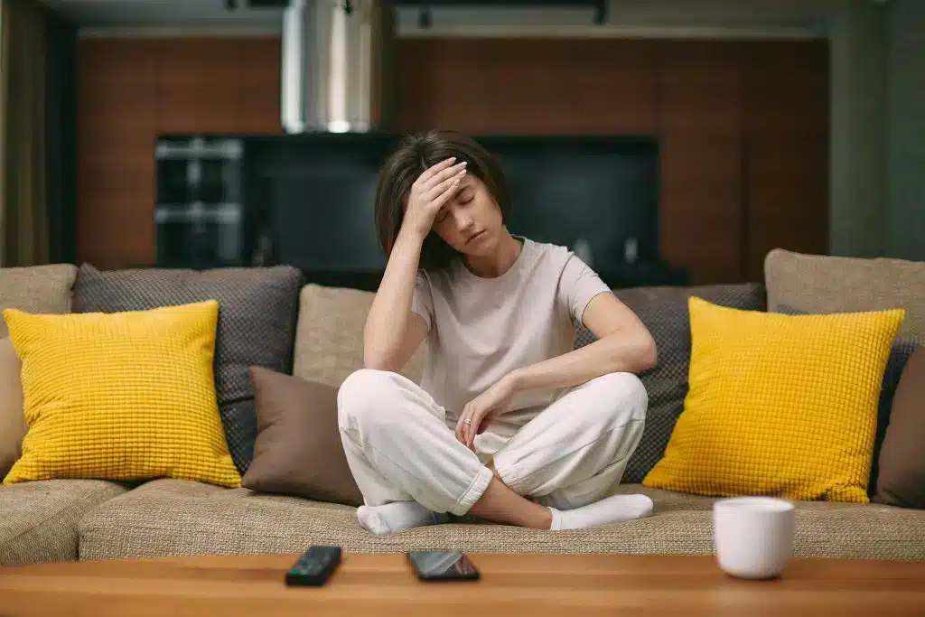 Women on a couch suffering from long covid Women on a couch suffering from long covid